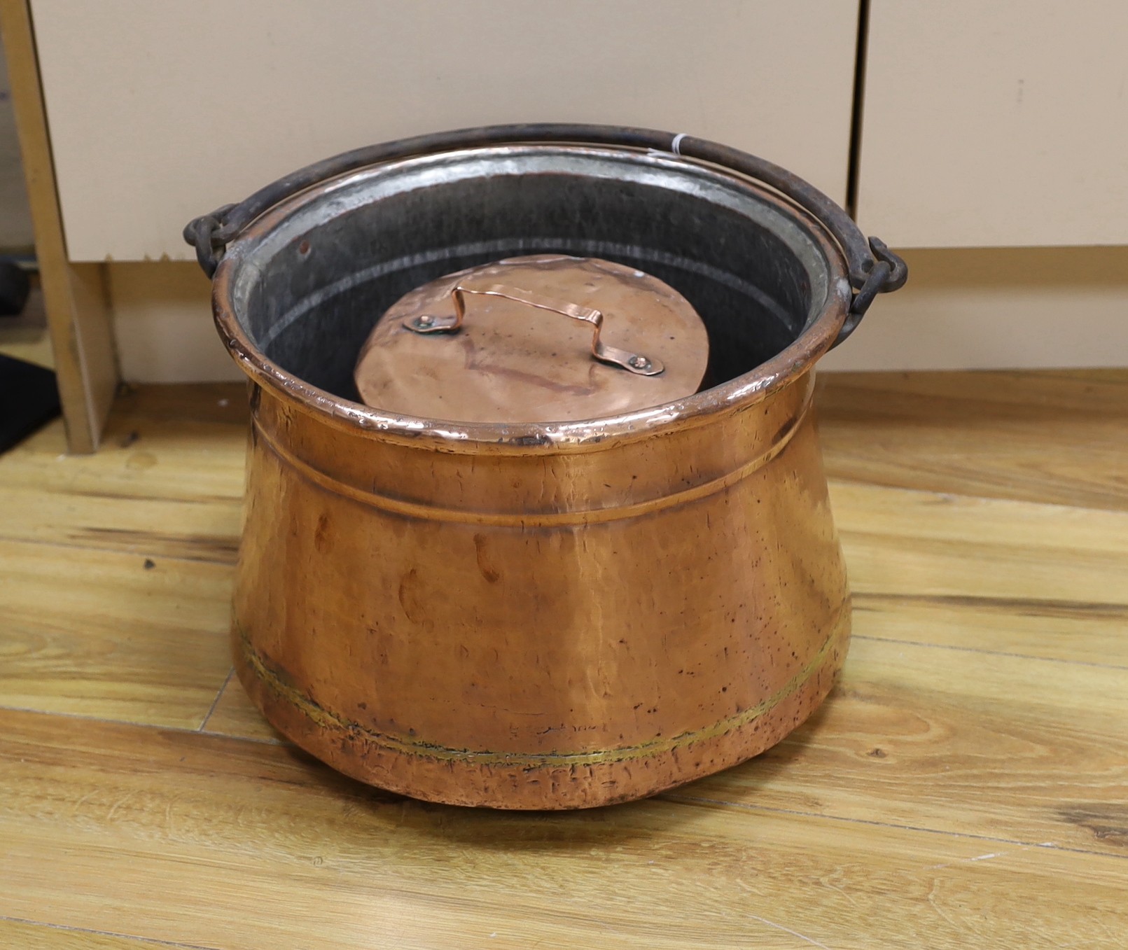 An 18th century French copper cauldron and two others